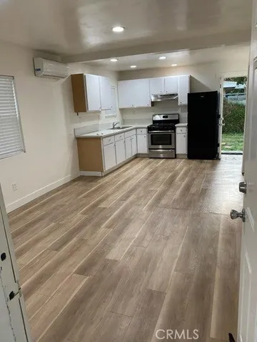 a large kitchen with a stove a refrigerator and a sink