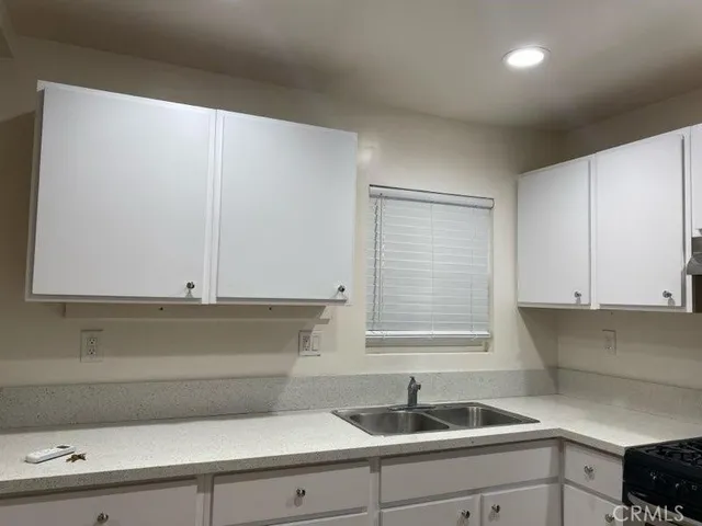 a kitchen with a sink and cabinets