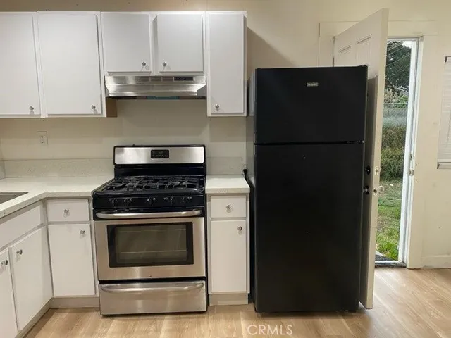 a kitchen with a stove and a refrigerator