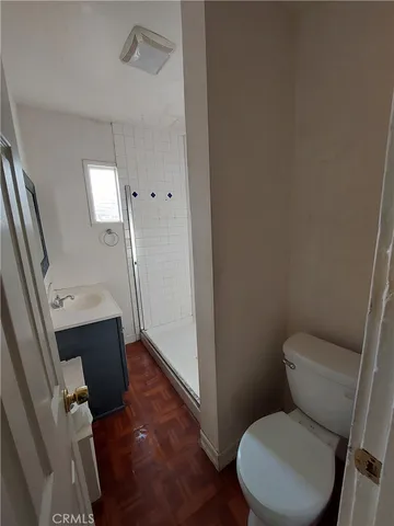 a white toilet sitting next to a sink