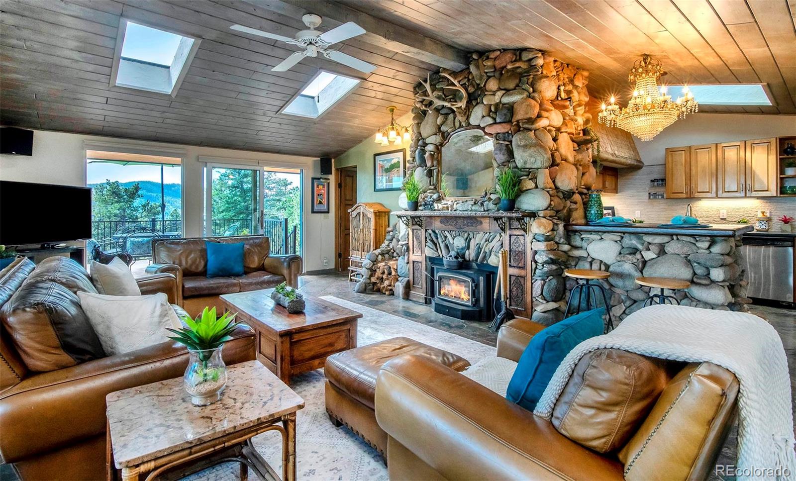 8838 South Hillview Road Morrison, CO 80465 - Photo 11 of 47 a living room with furniture and a fireplace