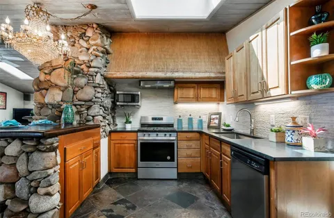 a kitchen with stainless steel appliances granite countertop a sink and cabinets