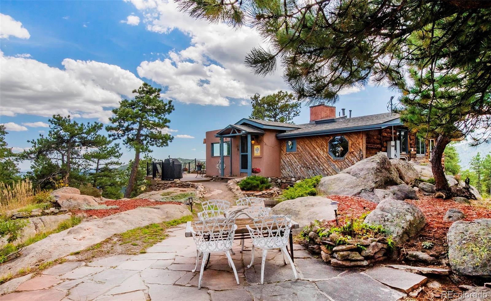 8838 South Hillview Road Morrison, CO 80465 - Photo 15 of 47 a view of a patio with table and chairs and potted plants