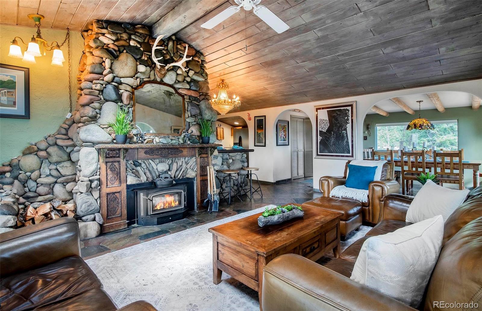 8838 South Hillview Road Morrison, CO 80465 - Photo 20 of 47 a living room with furniture and a fireplace