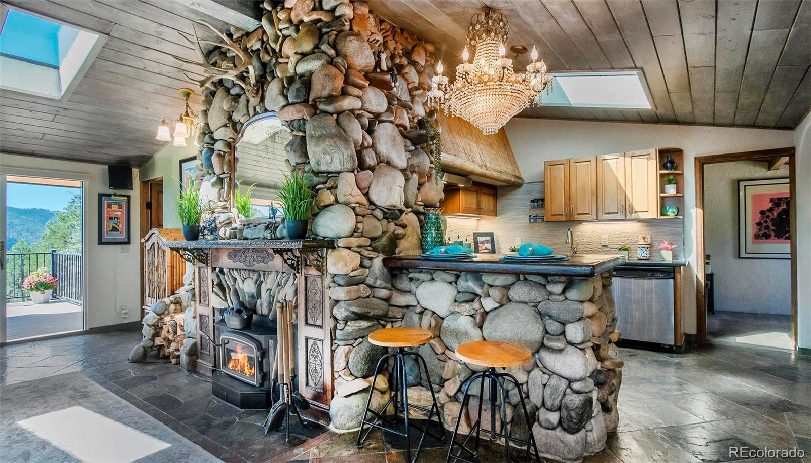 8838 South Hillview Road Morrison, CO 80465 - Photo 28 of 47 a view of entryway and hall with wooden floor