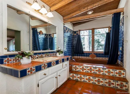 a bathroom with a sink mirror and a bathtub