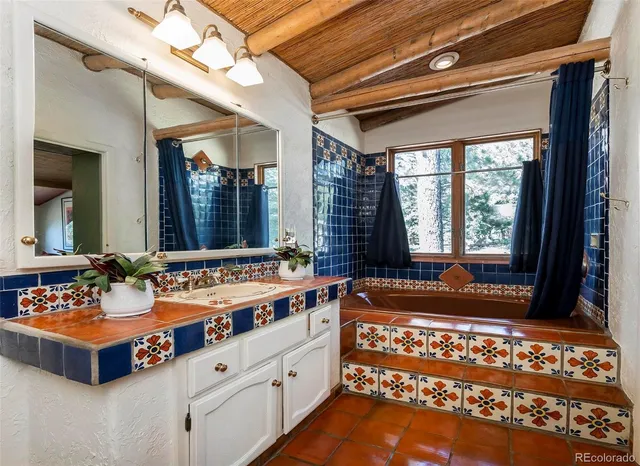 a bathroom with a sink mirror and a bathtub