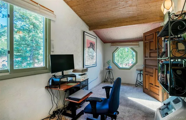 a living room with furniture a window and a flat screen tv