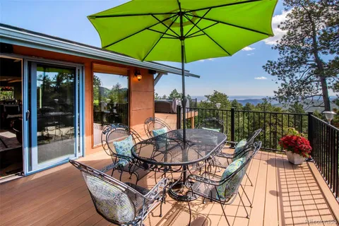 a view of a patio with a table chairs and a umbrella