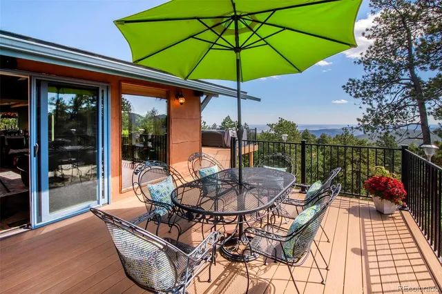 a view of a patio with a table chairs and a umbrella