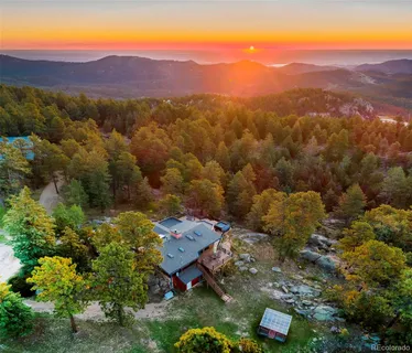 an aerial view of a houses with a yard