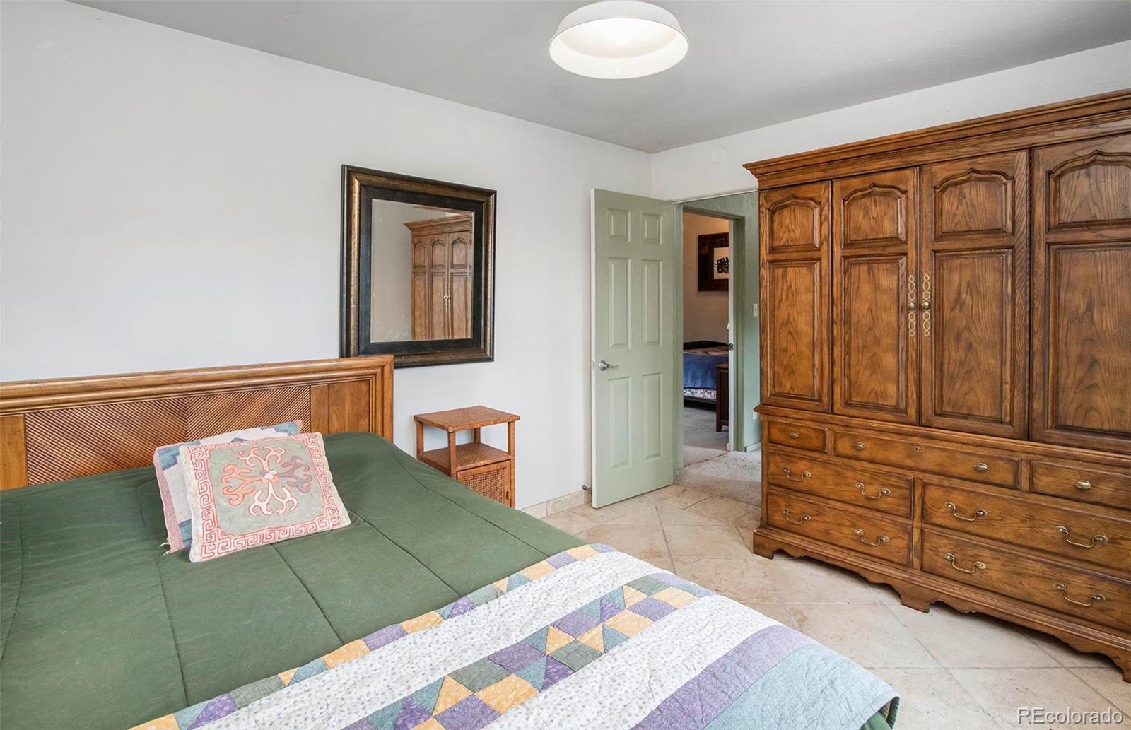 8838 South Hillview Road Morrison, CO 80465 - Photo 44 of 47 a bedroom with a bed and furniture