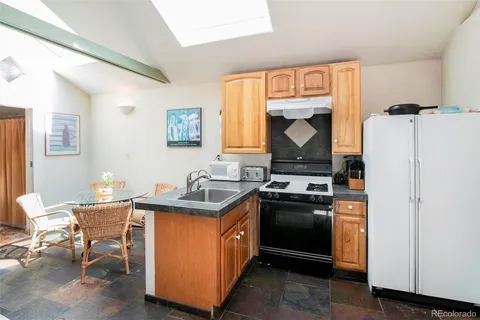 a kitchen with a stove window and cabinets