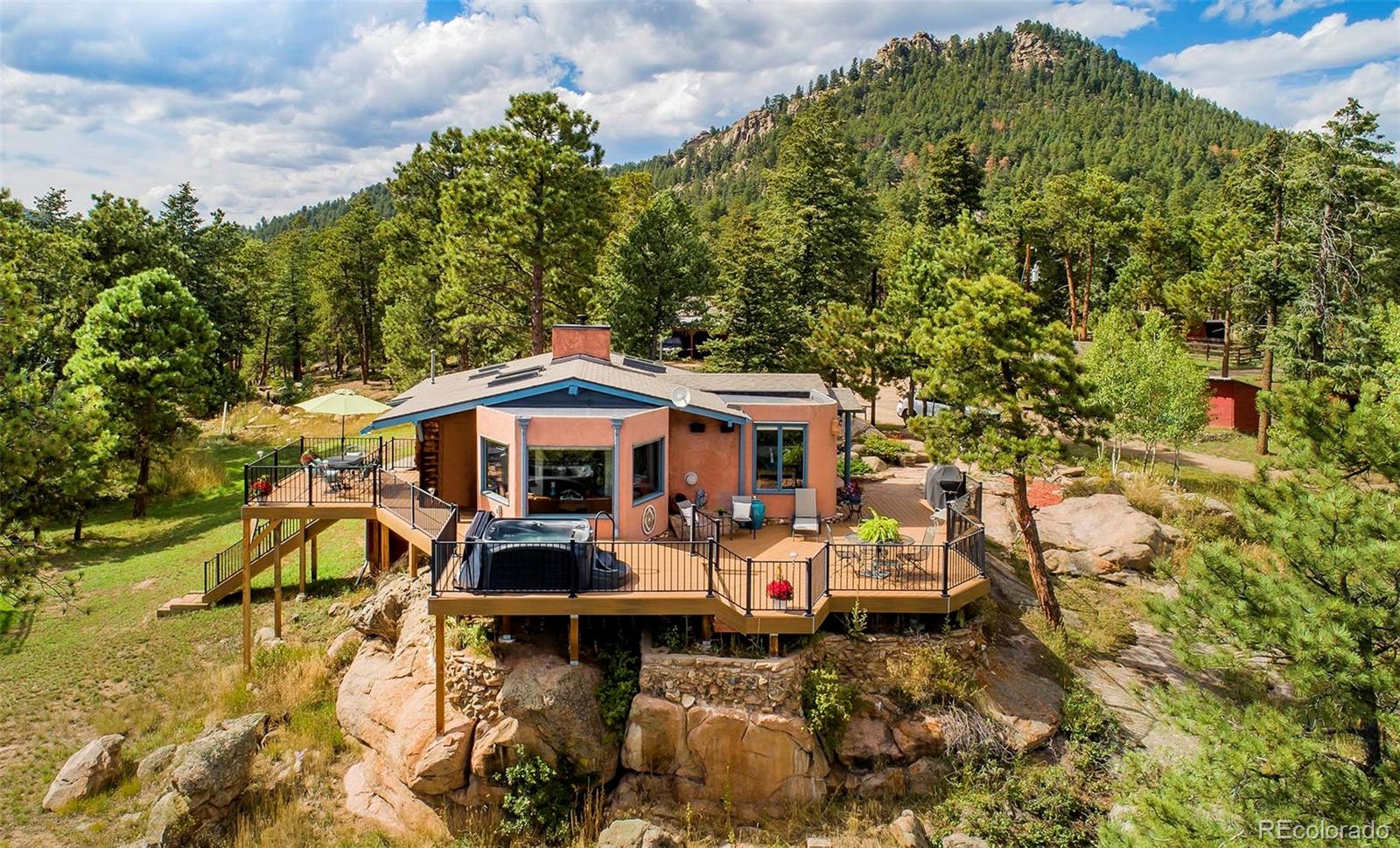 8838 South Hillview Road Morrison, CO 80465 - Photo 10 of 47 a view of a patio with table and chairs under an umbrella