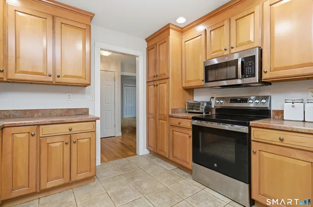 a kitchen with stainless steel appliances granite countertop a refrigerator stove and sink