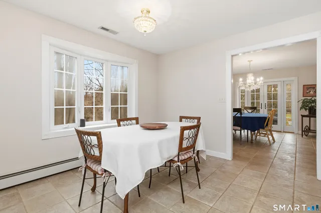 a view of a dining room with furniture and a window