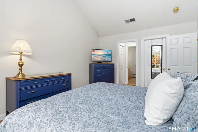 a bedroom with a bed and a dresser