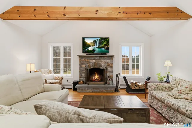 a living room with furniture and a fireplace