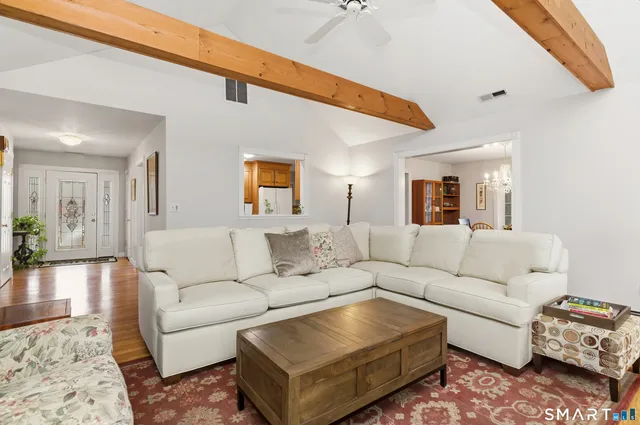 a living room with furniture wooden floor and a rug