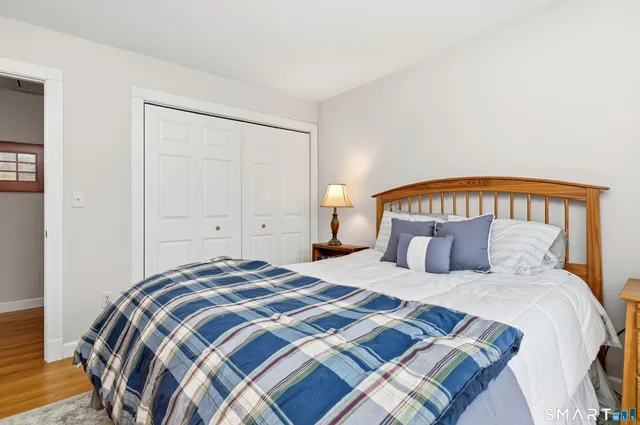 a bedroom with a large bed and a painting on the wall