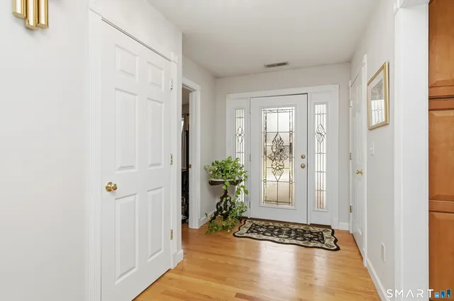 a view of an entryway with wooden floor