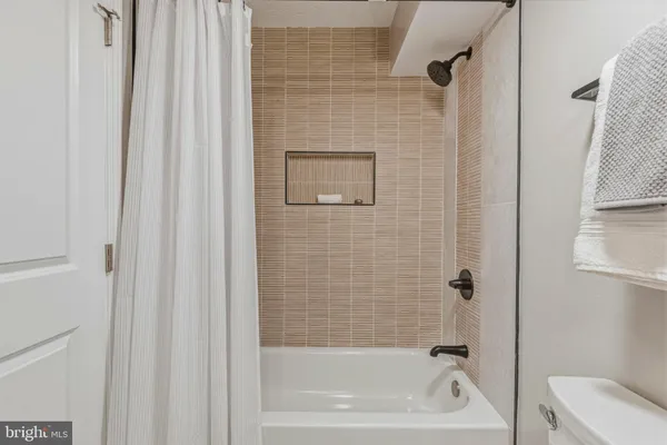 a bathroom with a tub and a shower curtain