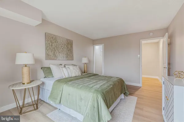 a bedroom with a bed and a lamp on table