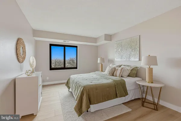 a bedroom with a large bed and a window