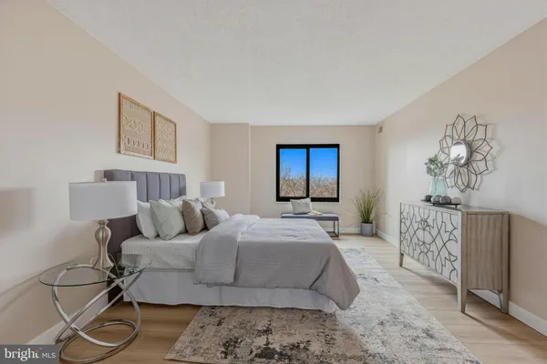 a bedroom with a large bed and a window