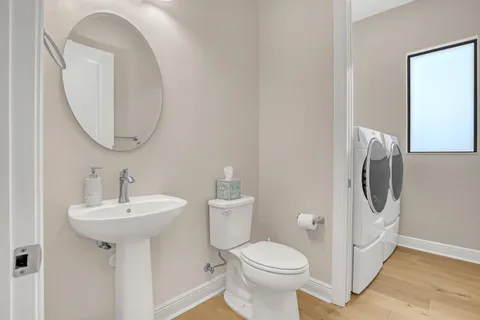 a bedroom with a bed and dresser with mirror