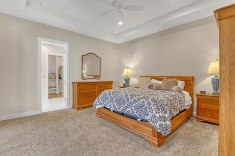 a bedroom with a bed and glass walk in closet