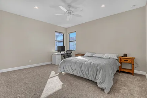 a bedroom with a bed and a desk