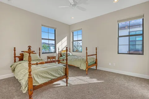 a bathroom with a granite countertop sink mirror vanity and toilet