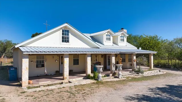 a front view of a house with sitting area and porch