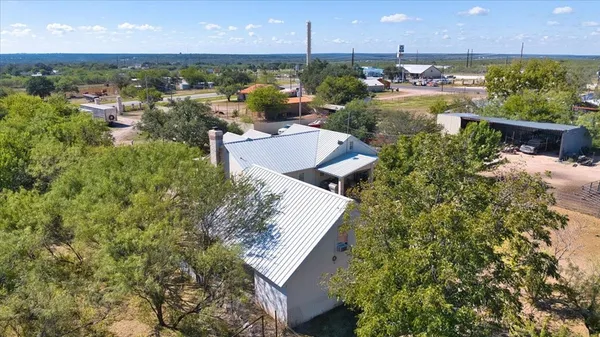 an aerial view of a house with a yard and outdoor seating