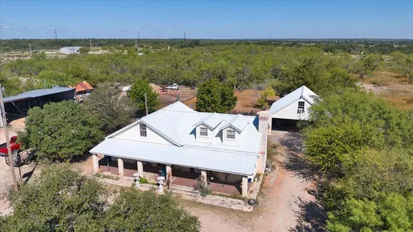 an aerial view of a house with a lake view