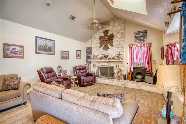 a living room with furniture a fireplace and a flat screen tv