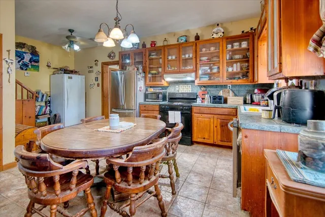 a dining table with chairs and chandelier