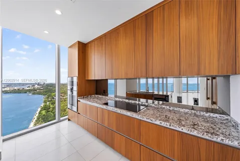 a spacious bedroom with a large bed and a large window