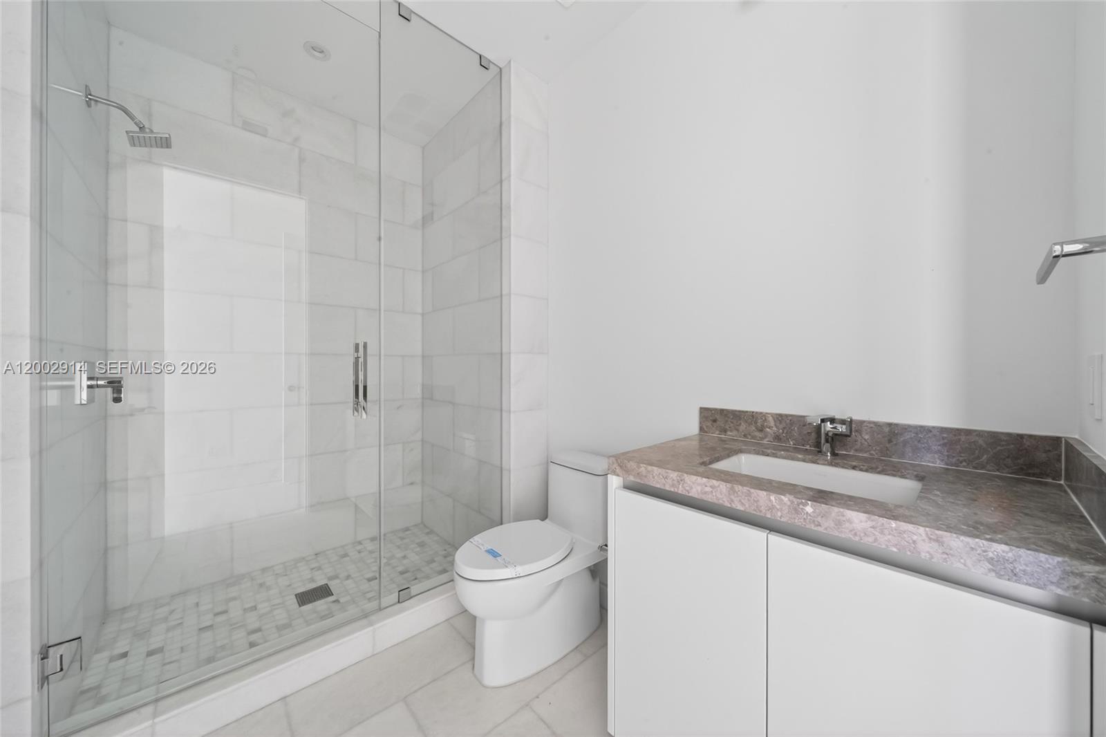 175 Southeast 25th Road, Unit 2602 Miami, FL 33129 - Photo 23 of 74 a bathroom with a granite countertop sink a toilet and shower
