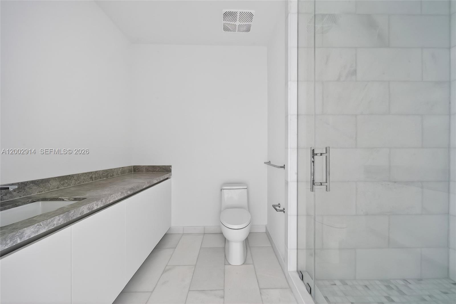 175 Southeast 25th Road, Unit 2602 Miami, FL 33129 - Photo 24 of 74 a spacious bathroom with a granite countertop toilet and a sink