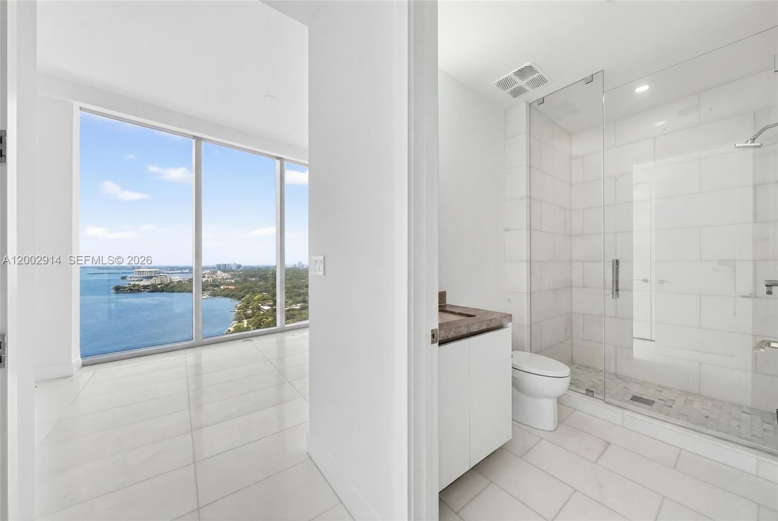 175 Southeast 25th Road, Unit 2602 Miami, FL 33129 - Photo 25 of 74 a bathroom with a granite countertop sink a toilet and shower