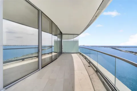 an aerial view of a brick house with a yard and potted plants