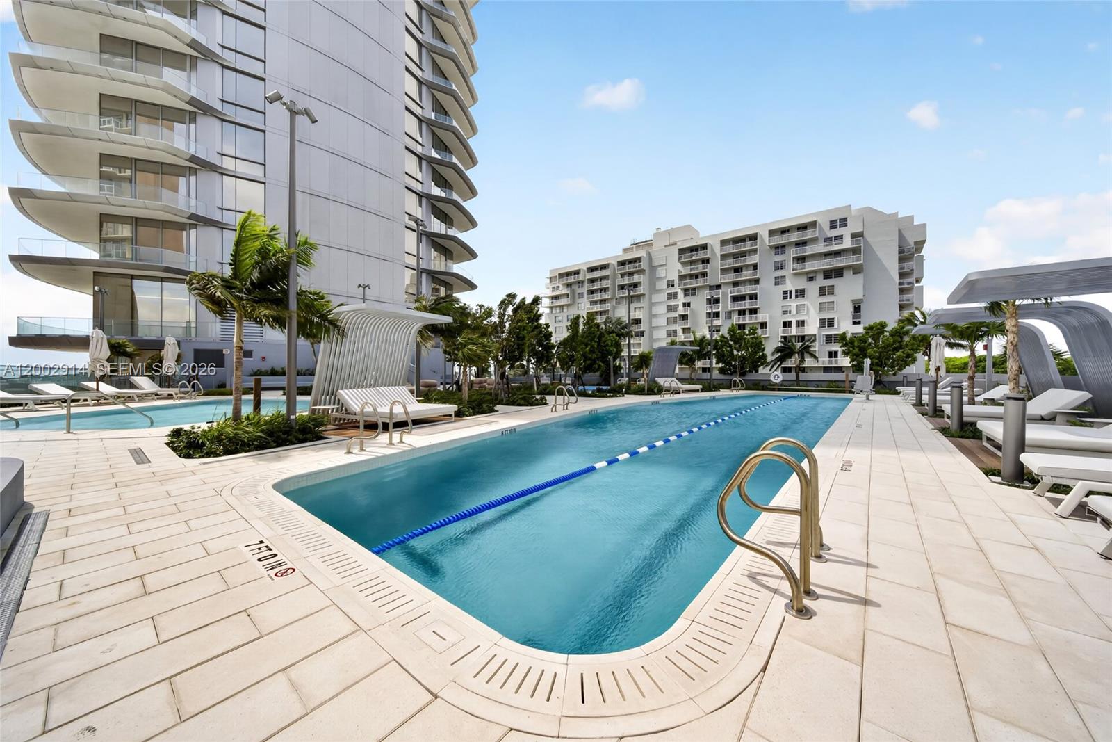 175 Southeast 25th Road, Unit 2602 Miami, FL 33129 - Photo 44 of 74 a view of a swimming pool with a lounge chair