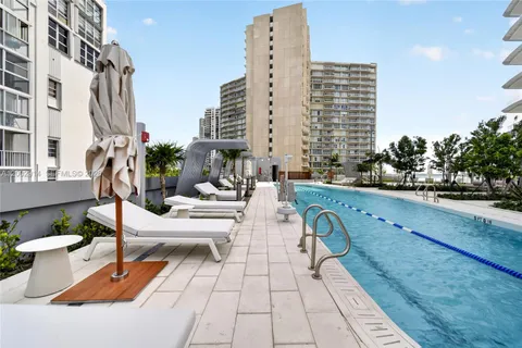 a dining room with furniture and a floor to ceiling window