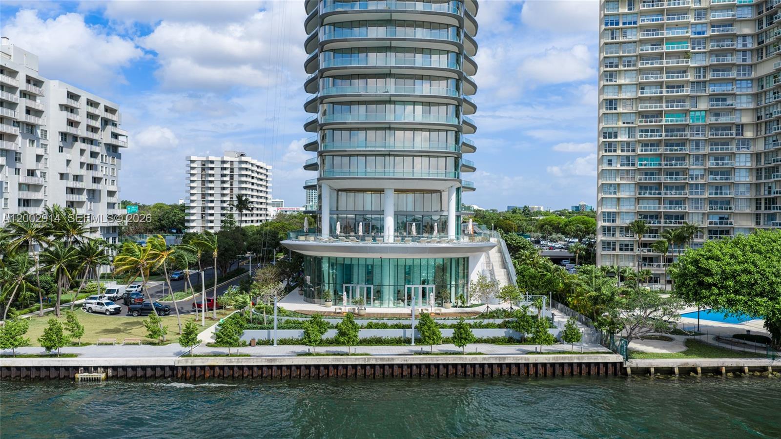 175 Southeast 25th Road, Unit 2602 Miami, FL 33129 - Photo 73 of 74 a front view of a building with lake view and trees in the background