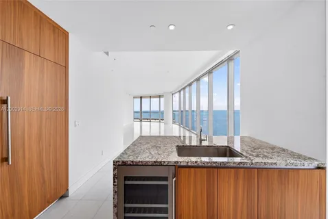 a kitchen with granite countertop sink and cabinets