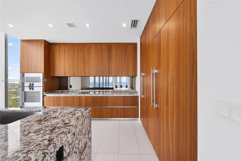 a kitchen with stainless steel appliances granite countertop a sink a stove and a microwave