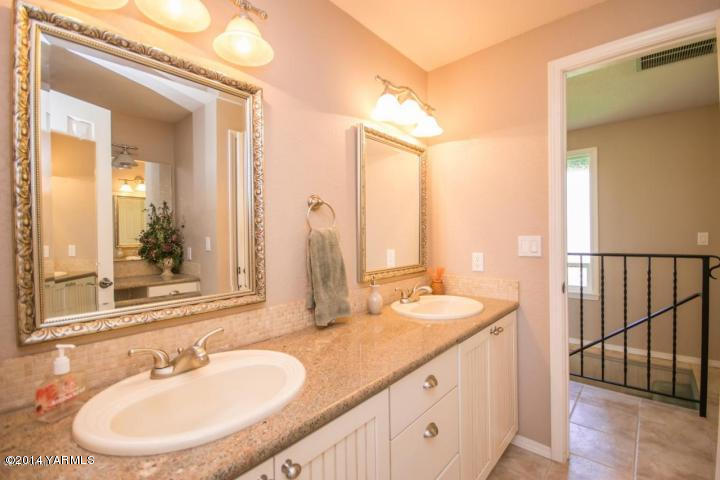 11301 Zier Road Yakima, WA 98908 - Photo 11 of 14 a bathroom with a double vanity sink and a mirror