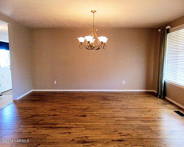 11301 Zier Road Yakima, WA 98908 - Photo 7 of 14 a view of a room with window wooden floor and a chandelier